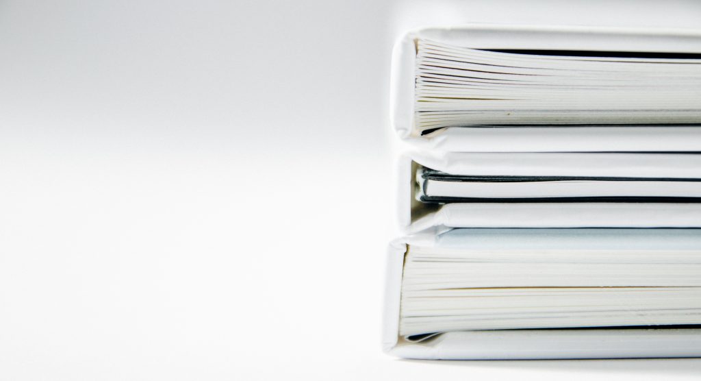 Image of white folders, filled with documents. A white paper is a leader's best friend.